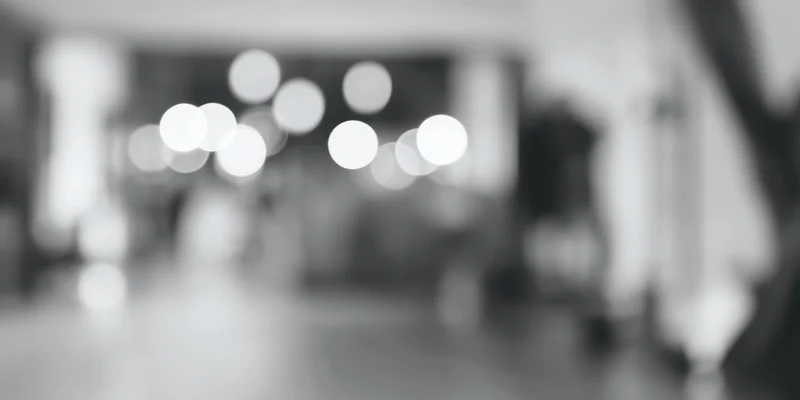 Blurred circular lights in a high-key grayscale interior space