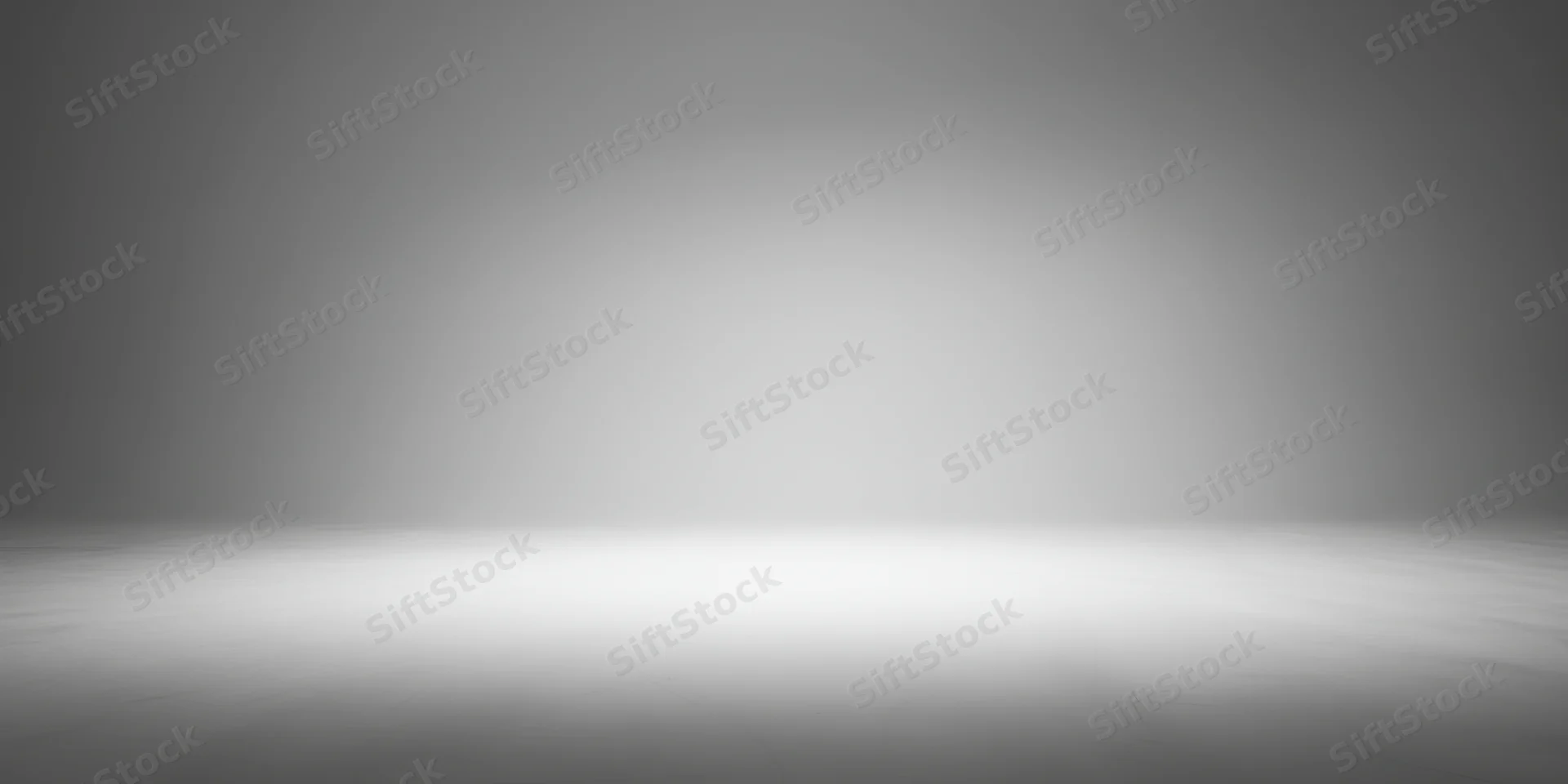 Empty studio with smooth grey gradient backdrop and reflective floor