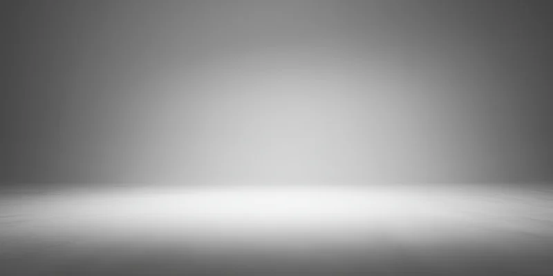 Empty studio with smooth grey gradient backdrop and reflective floor