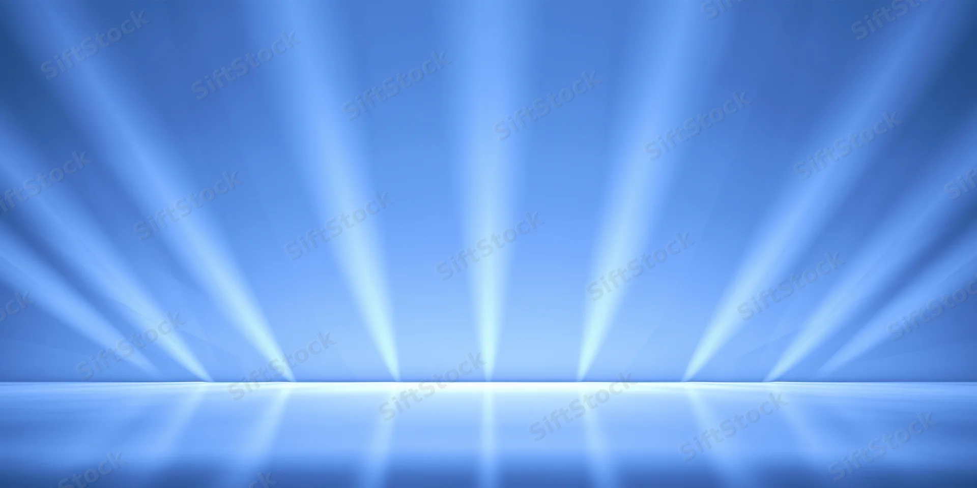 Blue-lit stage with diagonal light beams reflecting on the floor