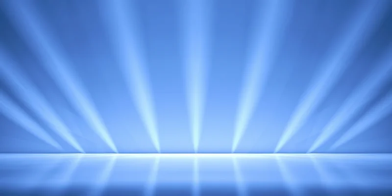 Blue-lit stage with diagonal light beams reflecting on the floor