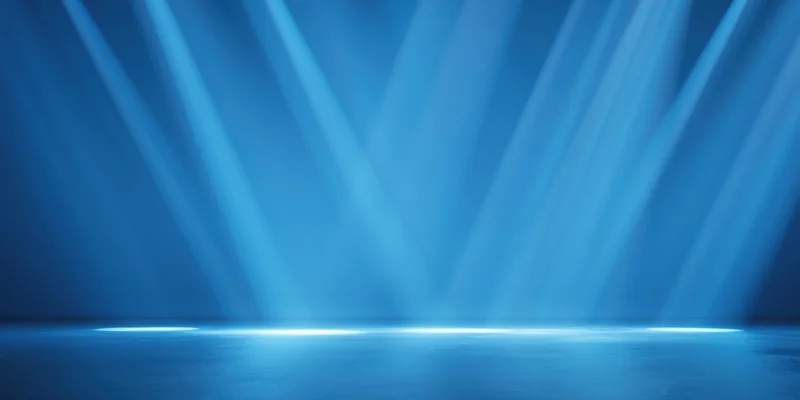 Diagonal blue light beams illuminating a minimalist stage floor