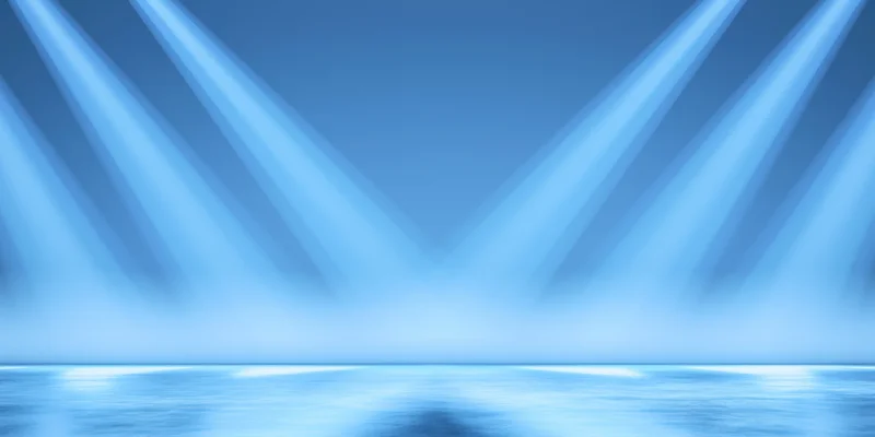 Diagonal blue light beams illuminating an empty glossy stage floor