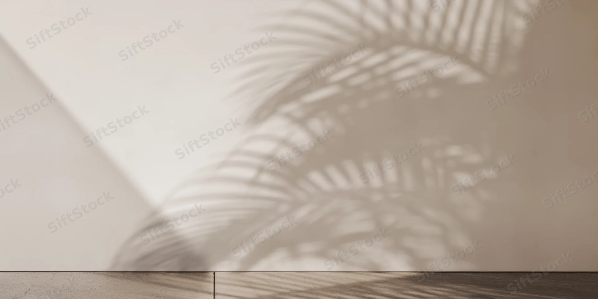 Palm leaf shadow projected on a pale plaster wall in a minimalist interior