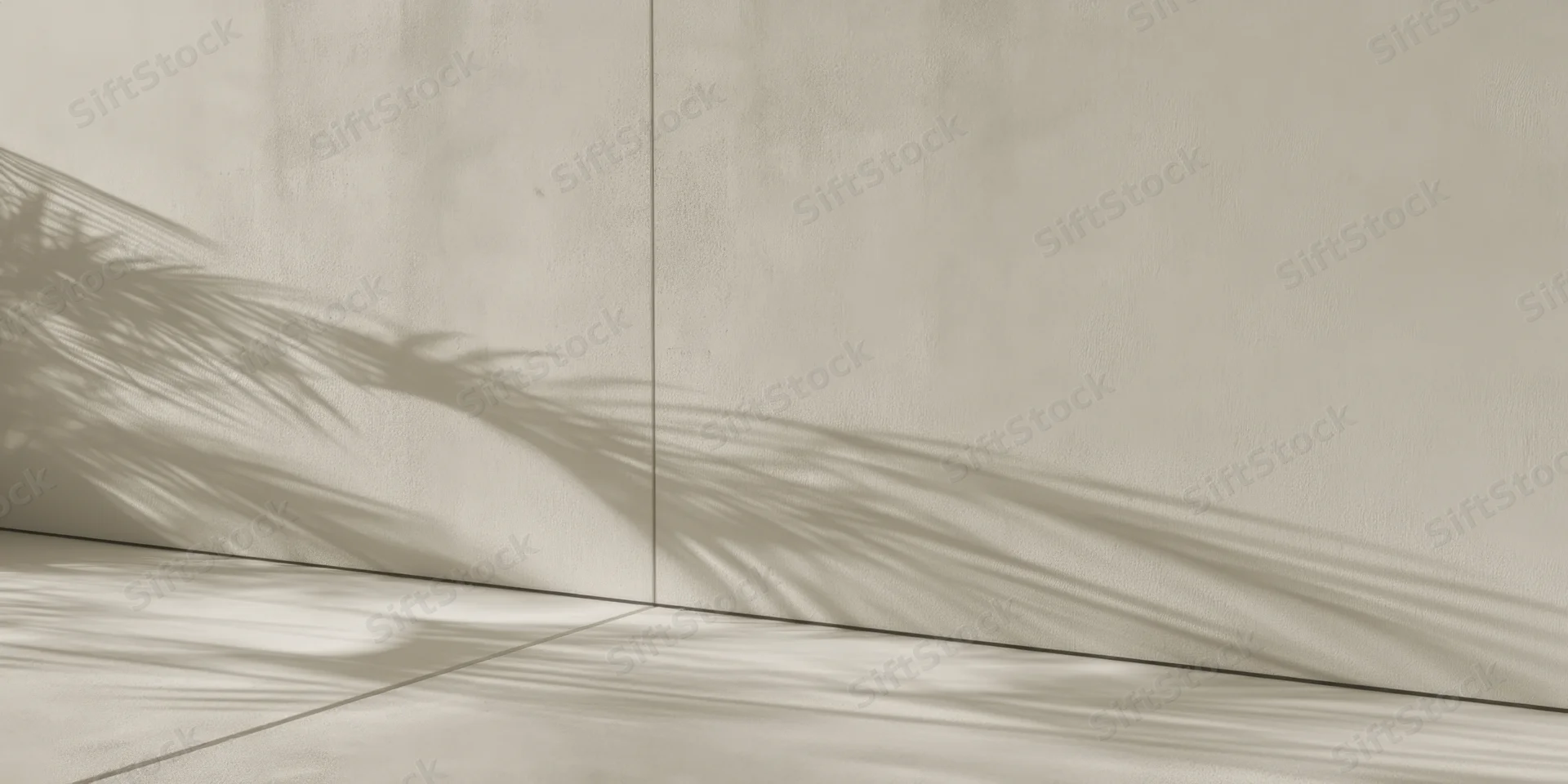 Palm leaf shadow on pale plaster wall and tiled floor in minimalist interior