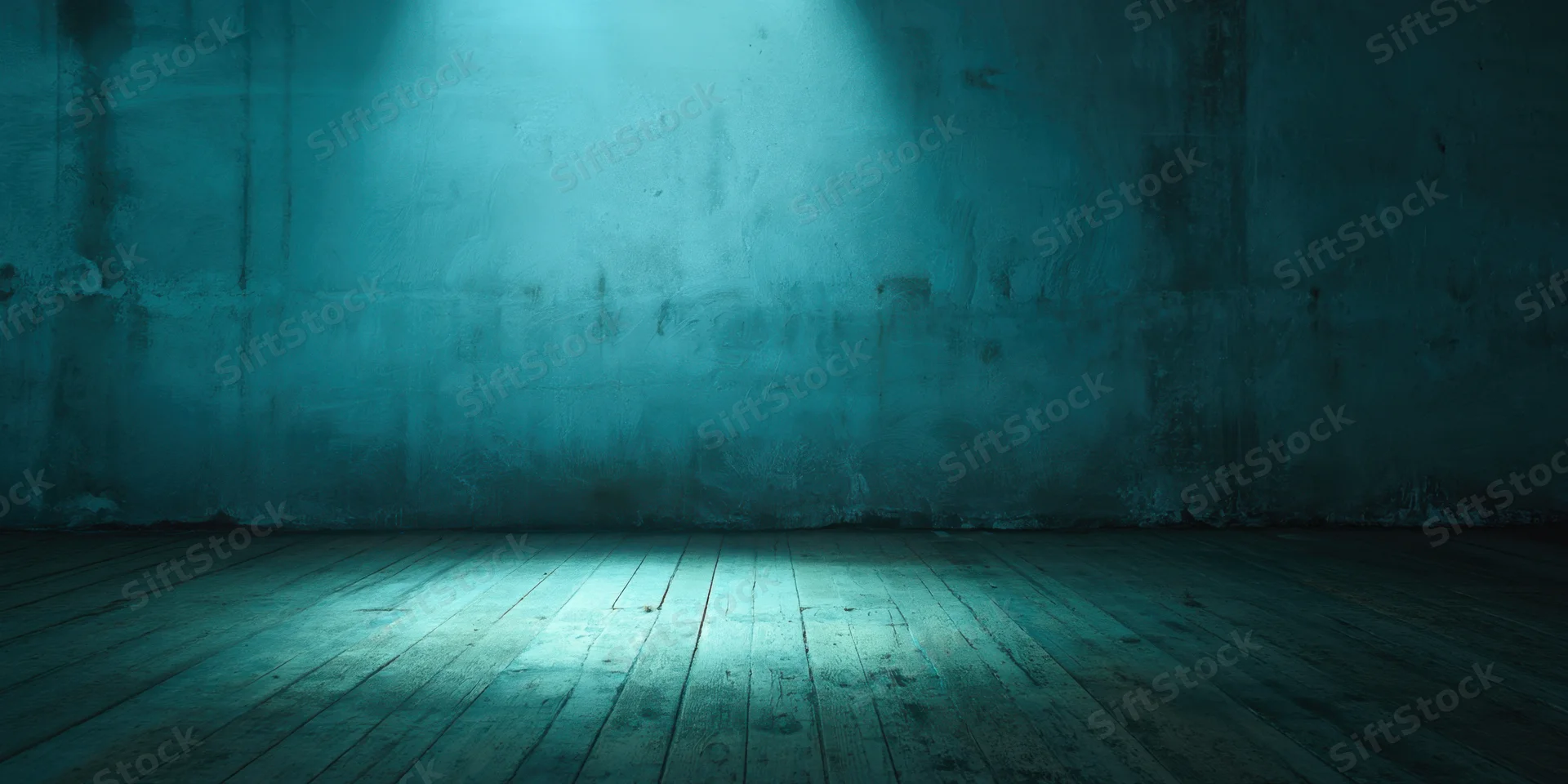Empty industrial room with spotlight on weathered concrete wall and wooden floor