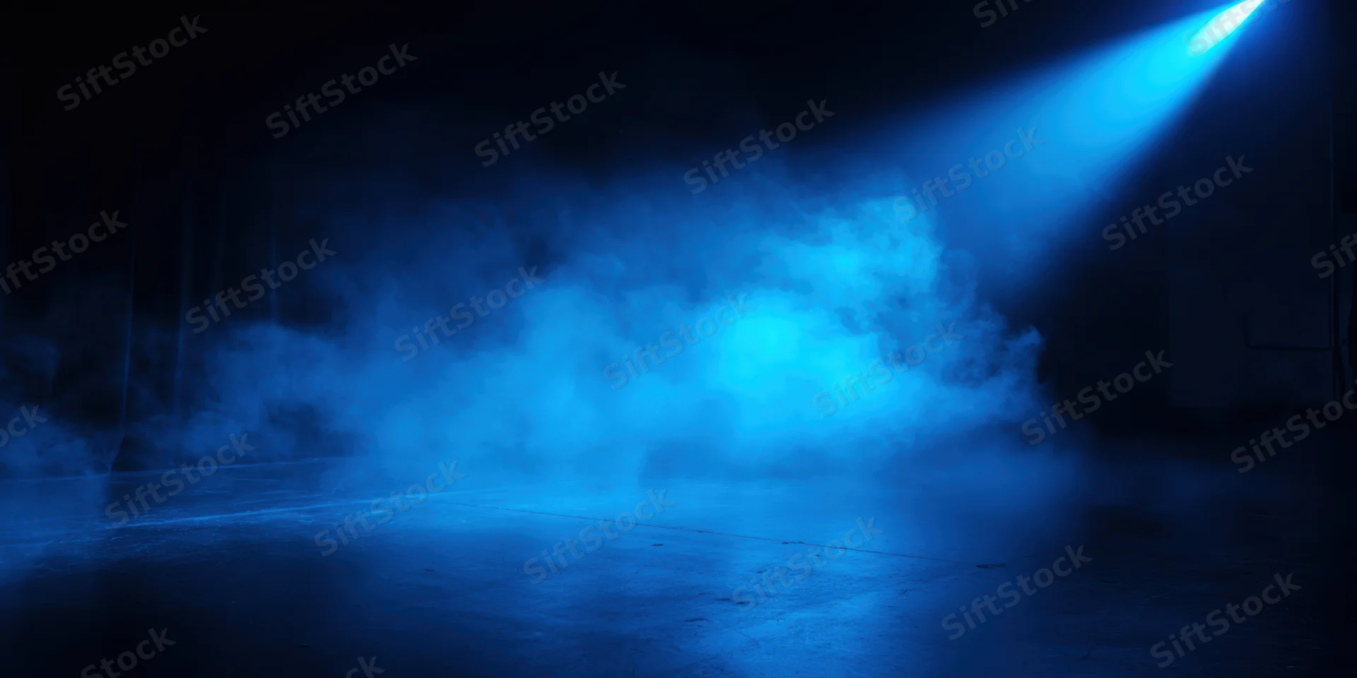 Blue spotlight illuminating drifting fog on an empty stage floor