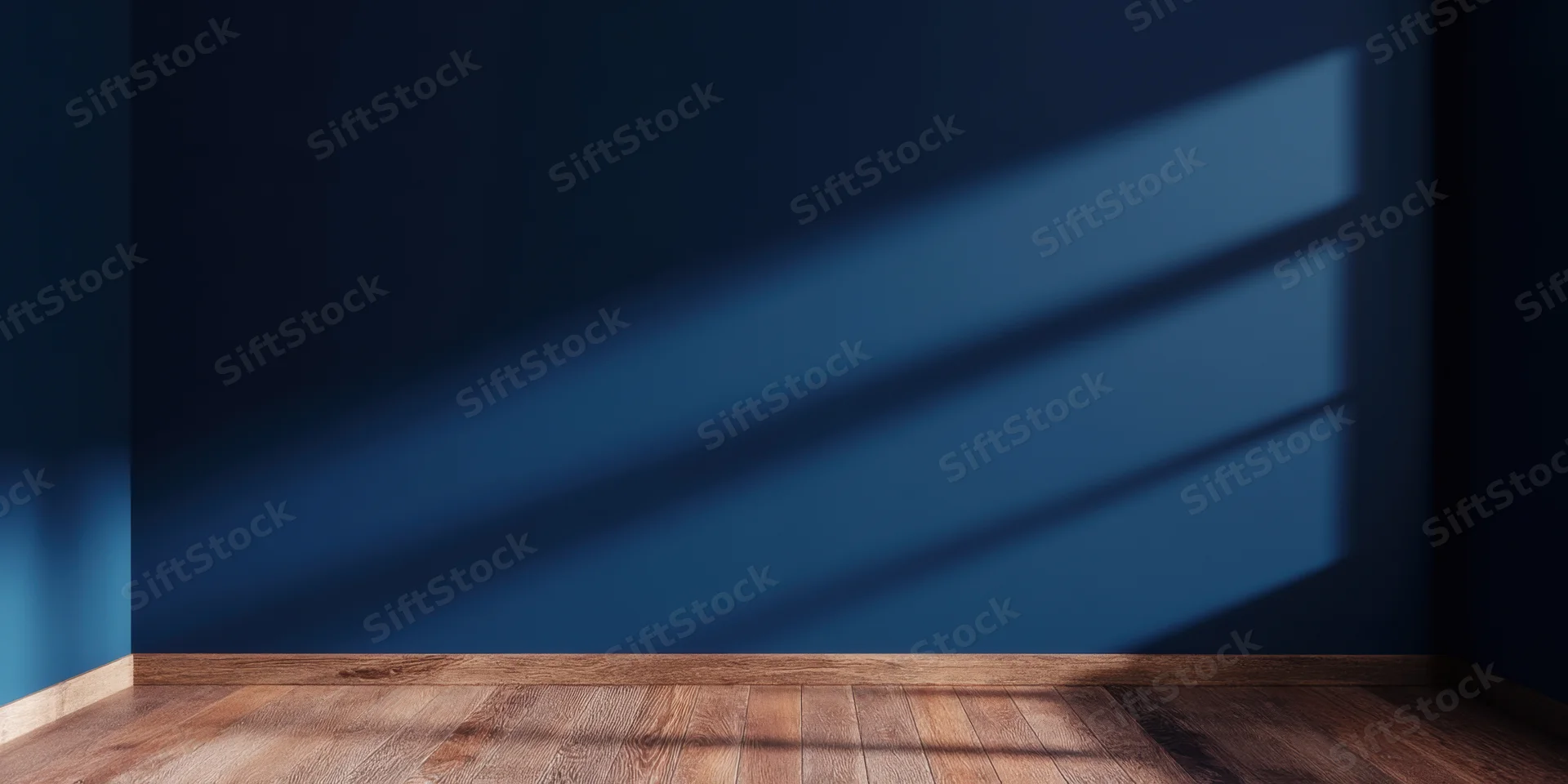 Empty room with deep blue wall and wooden floor showing sunlight shadows from a window