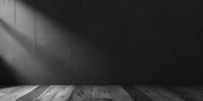 Dark textured wall with wooden floor and diagonal light shadow in empty interior space