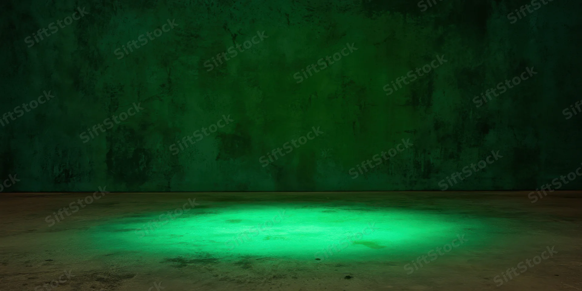 Green spotlight on concrete floor in dark textured studio space