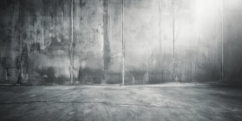 Weathered concrete wall and floor in an empty industrial interior space