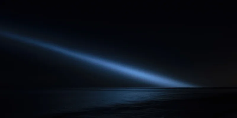 Diagonal blue light beam across dark night sea horizon