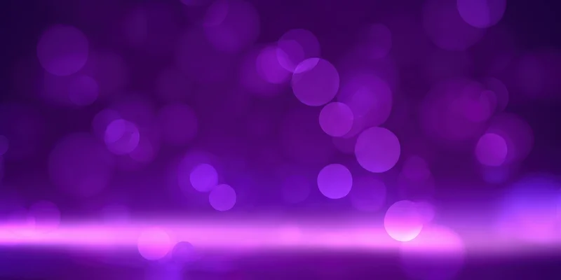 Soft purple bokeh lights blurred across a gradient background with a glowing horizontal band