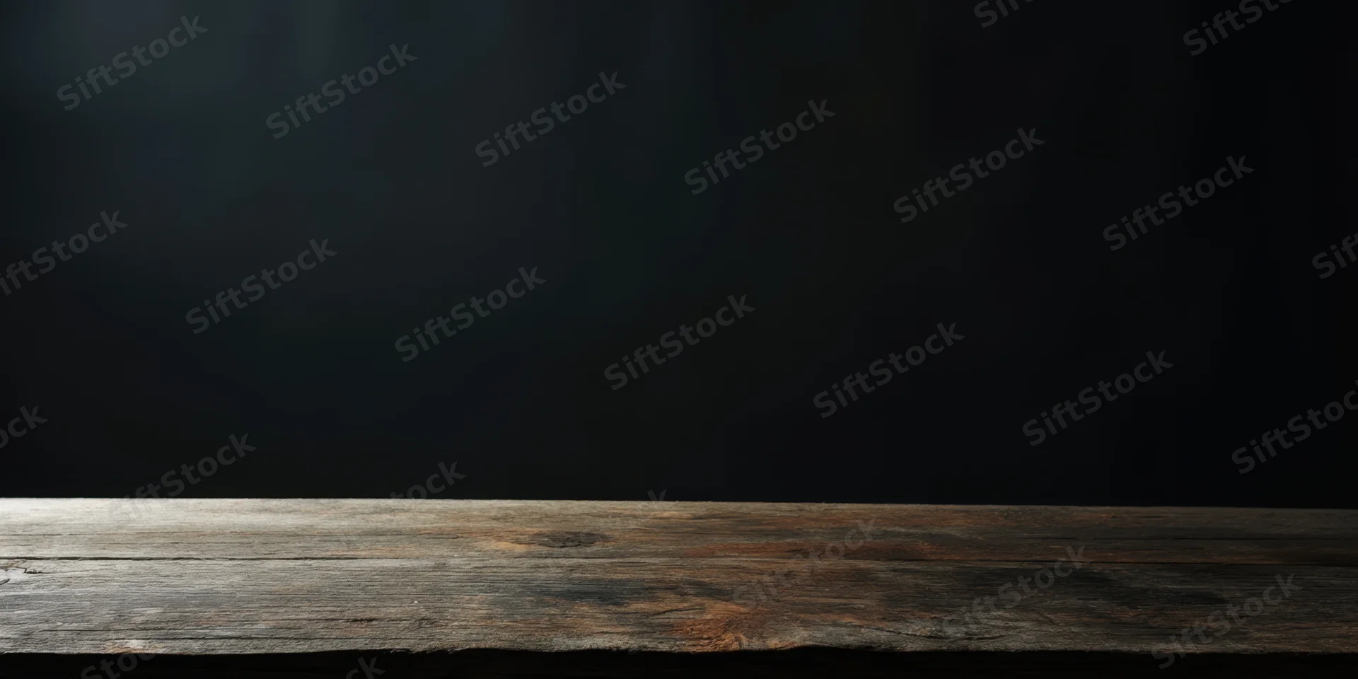 Weathered wooden table surface against dark studio wall with copyspace