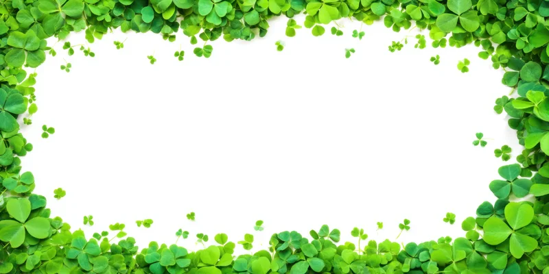 Green clover leaves arranged in a border frame around a white background