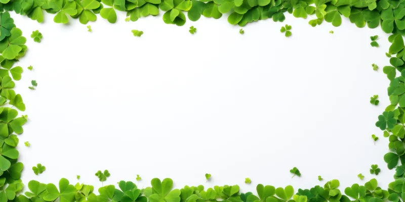 Green clover leaves arranged in a border frame on white background with central copyspace