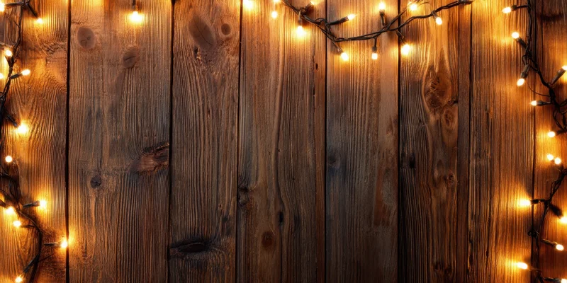 Warm string lights framing a rustic wooden wall with vertical planks and natural grain