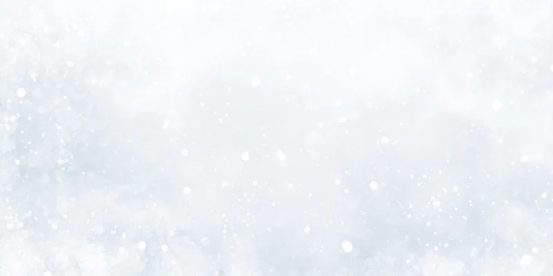 Soft snowfall drifting across a white winter sky with gentle bokeh and copyspace