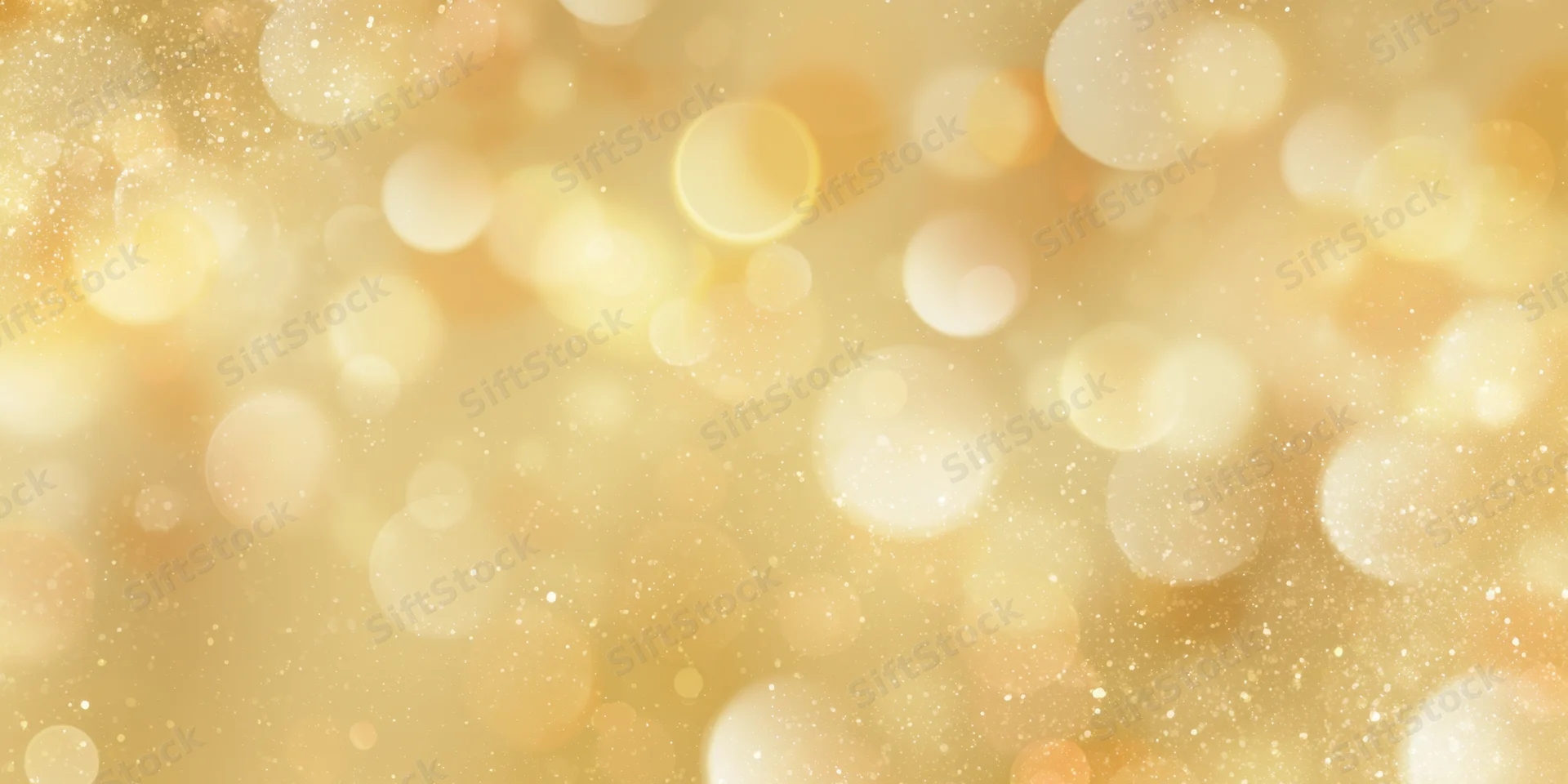 Soft golden background with round bokeh lights and sparkling particles