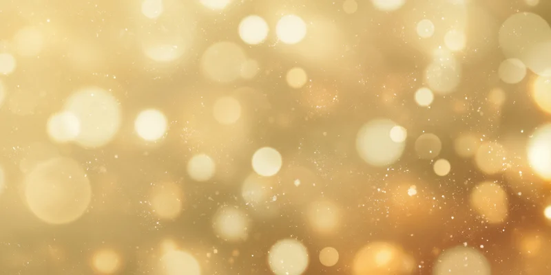 Soft golden background with round bokeh lights and sparkling particles