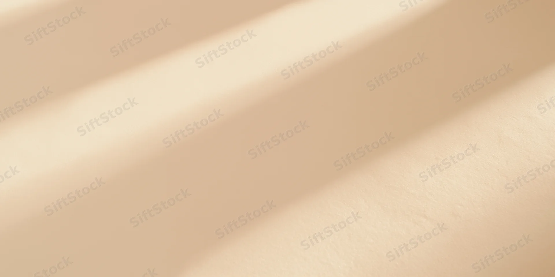 Soft sunlight casting diagonal shadows across a beige textured surface