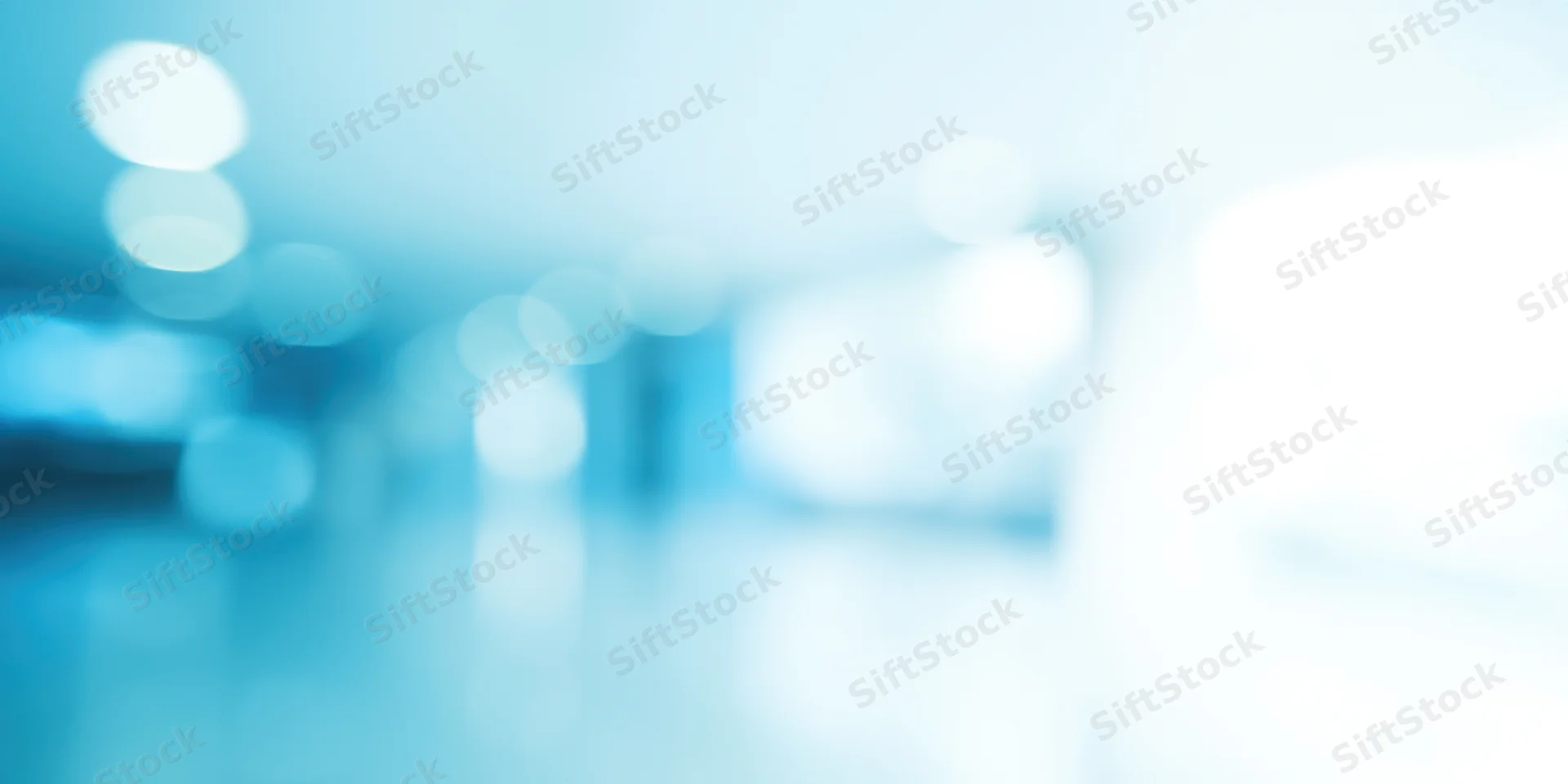 Softly blurred empty office interior with cool blue tones and bokeh lighting