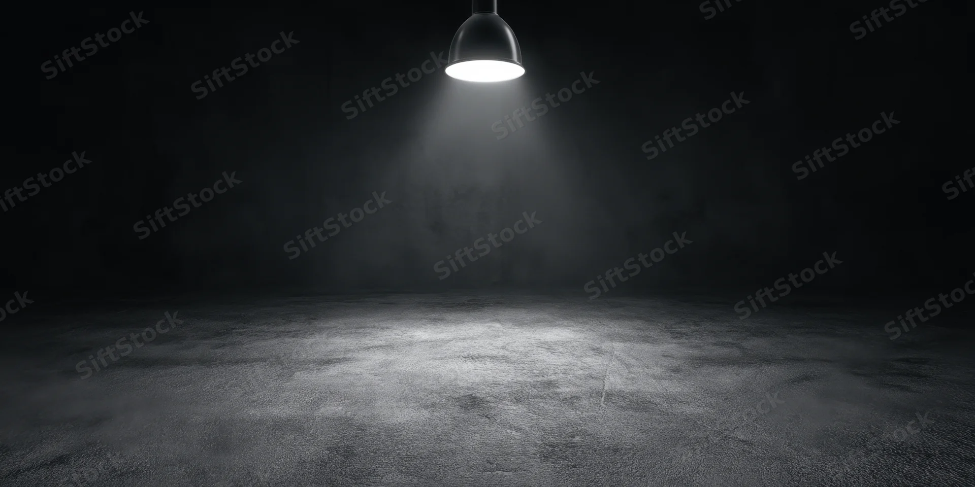 Empty stage illuminated by a single overhead spotlight on a concrete floor