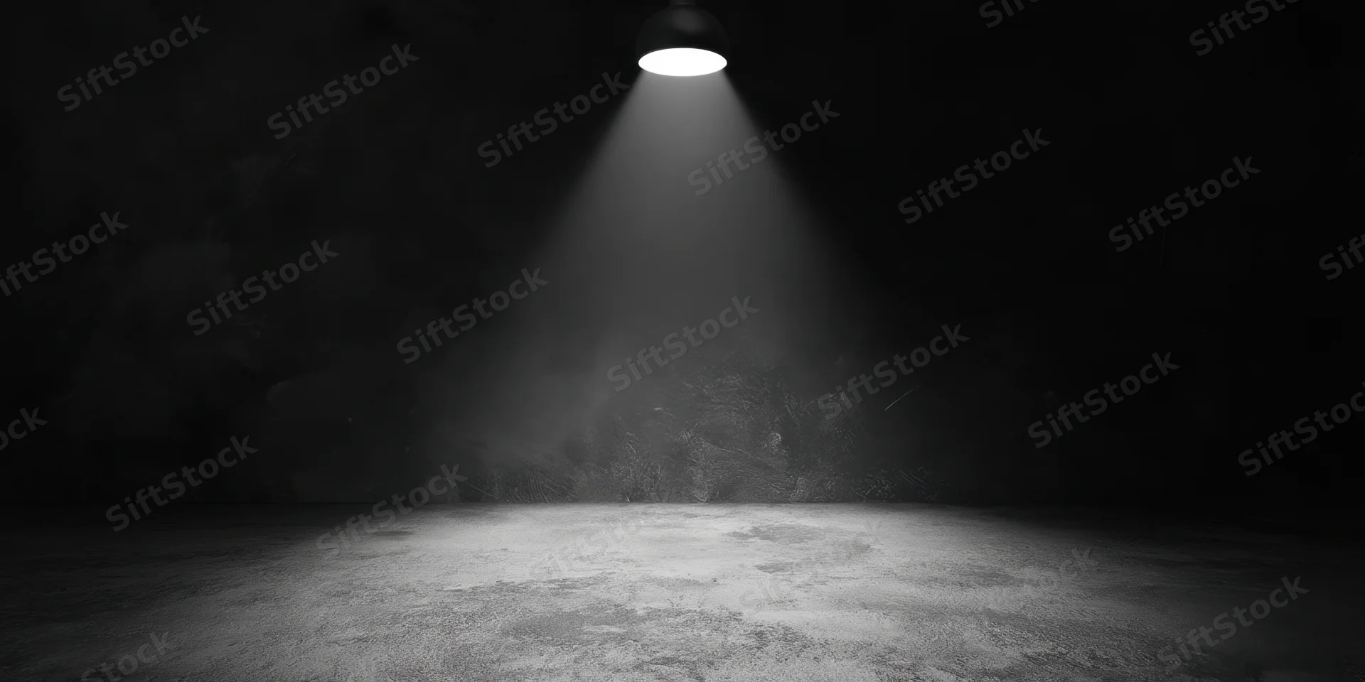 Empty stage illuminated by a single overhead spotlight in a dark theater space