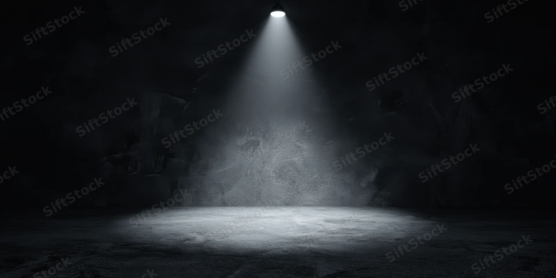 Empty stage illuminated by a single overhead spotlight in a dark theater interior