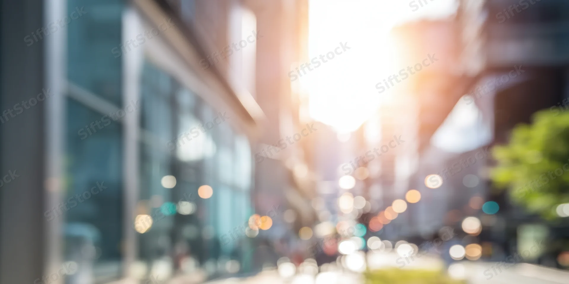 Sunlit urban street with glass-fronted buildings and soft bokeh lights in the background