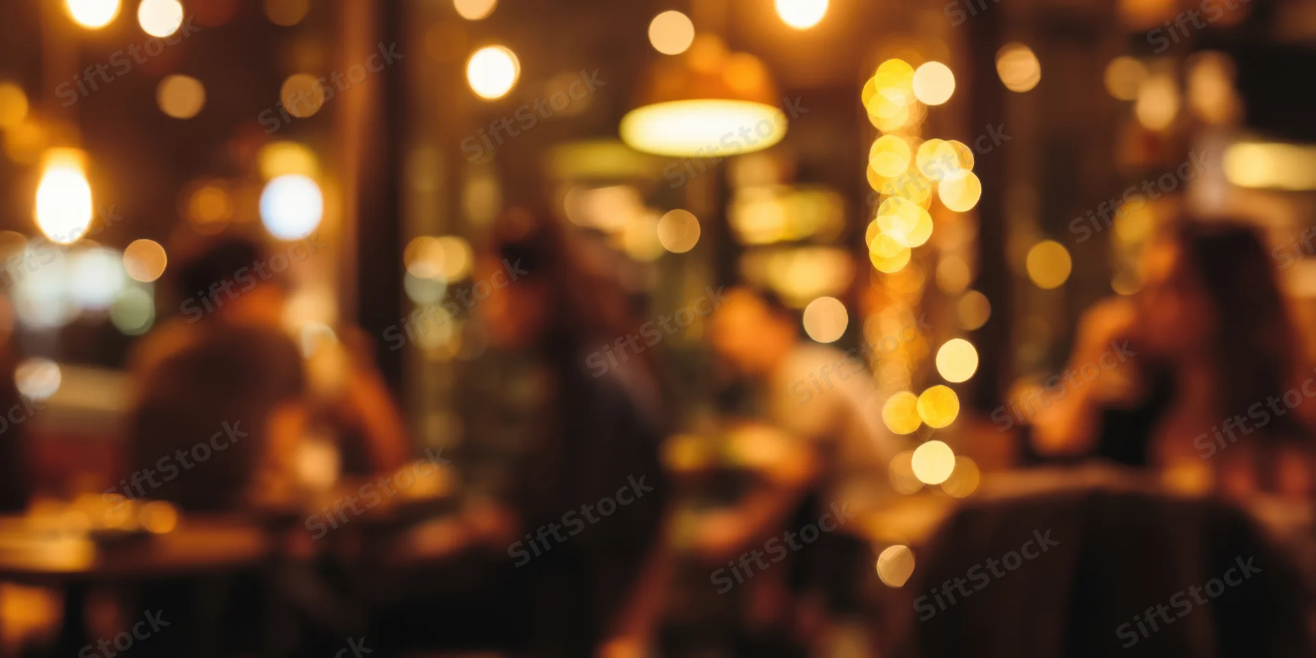Blurred silhouettes of patrons socializing in a dimly lit cafe interior