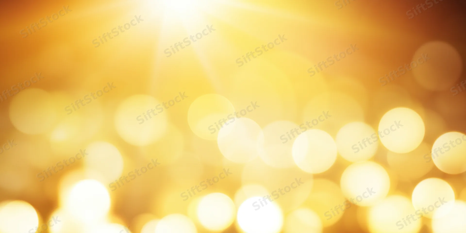 Warm golden bokeh lights softly blurred in circular patterns across the frame