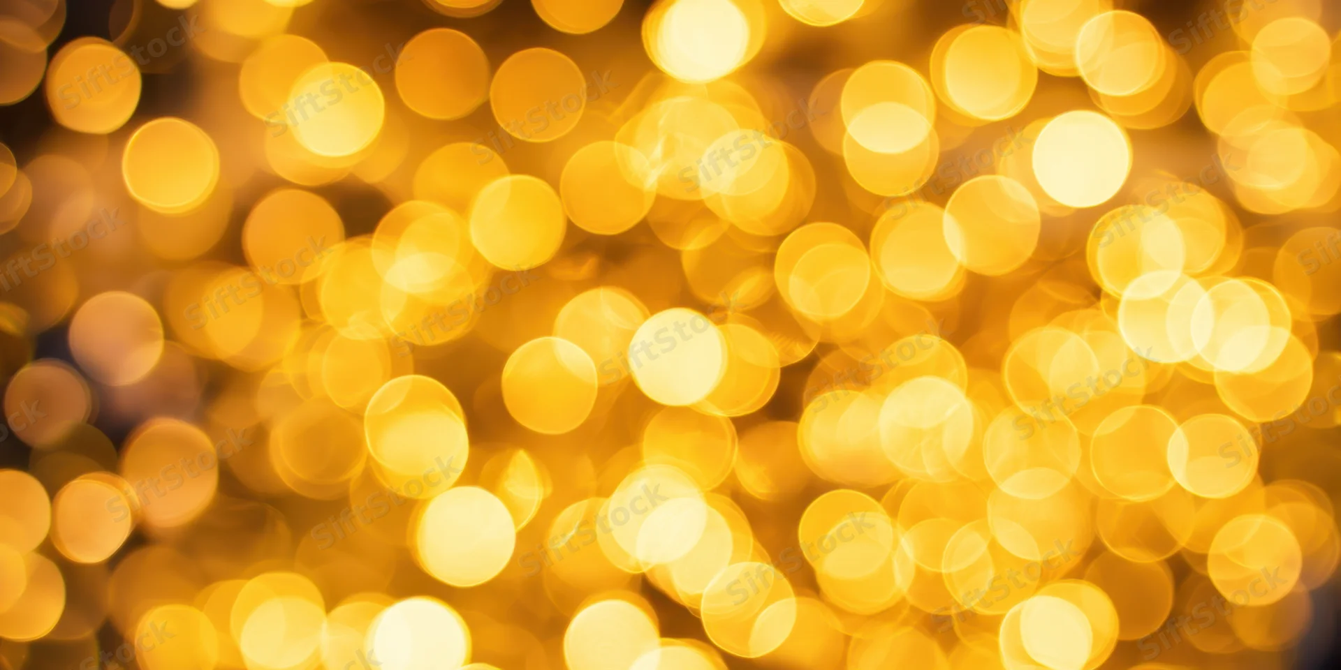 Golden bokeh lights arranged in a warm abstract background