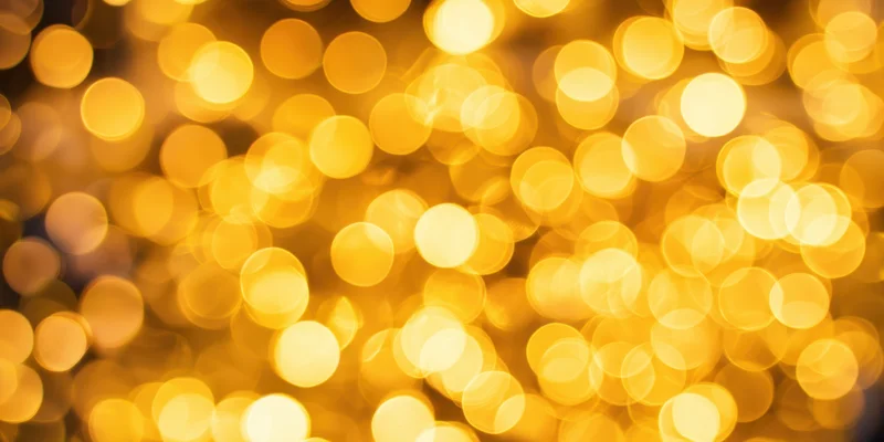 Golden bokeh lights arranged in a warm abstract background
