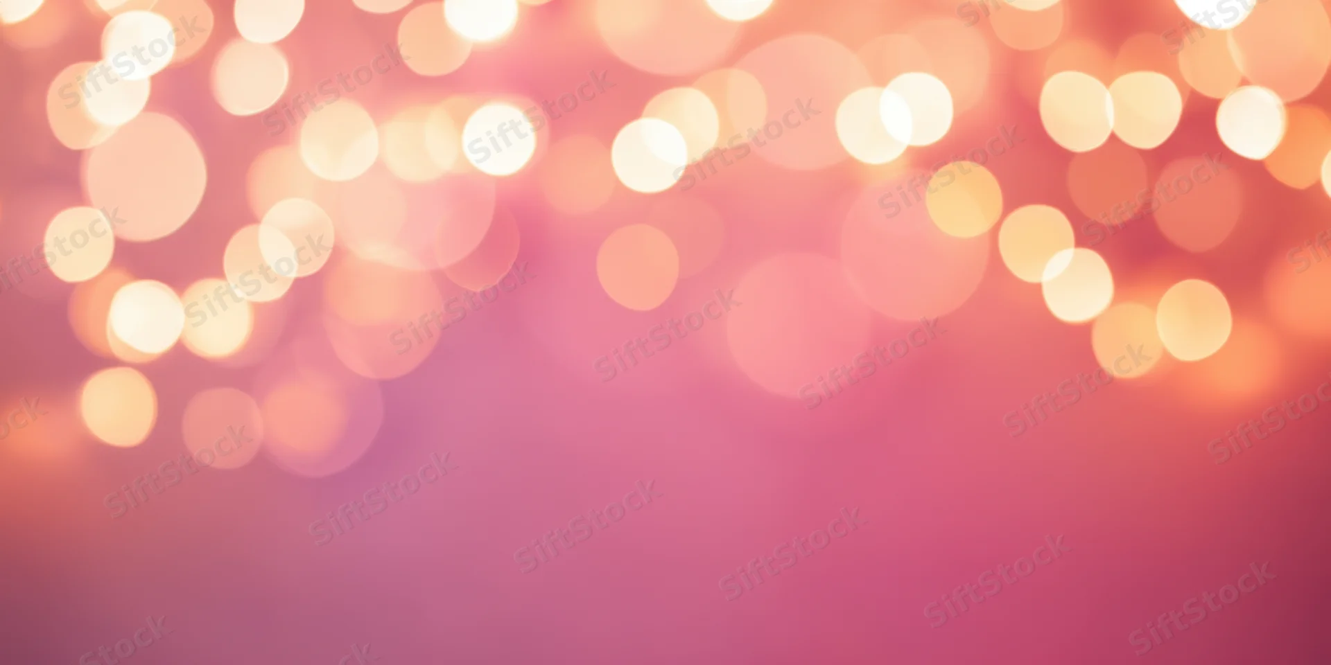 Soft pink bokeh background with warm glowing orbs of light arranged across the top, leaving copyspace below