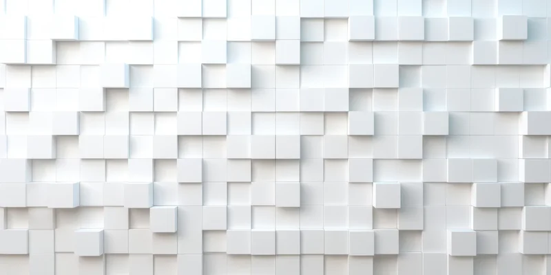 White geometric cubes arranged in a 3d pattern on a wall surface