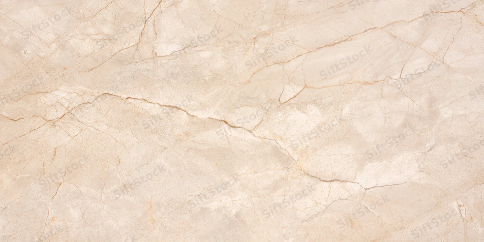 Close-up of a beige stone surface with delicate veining and natural cracks