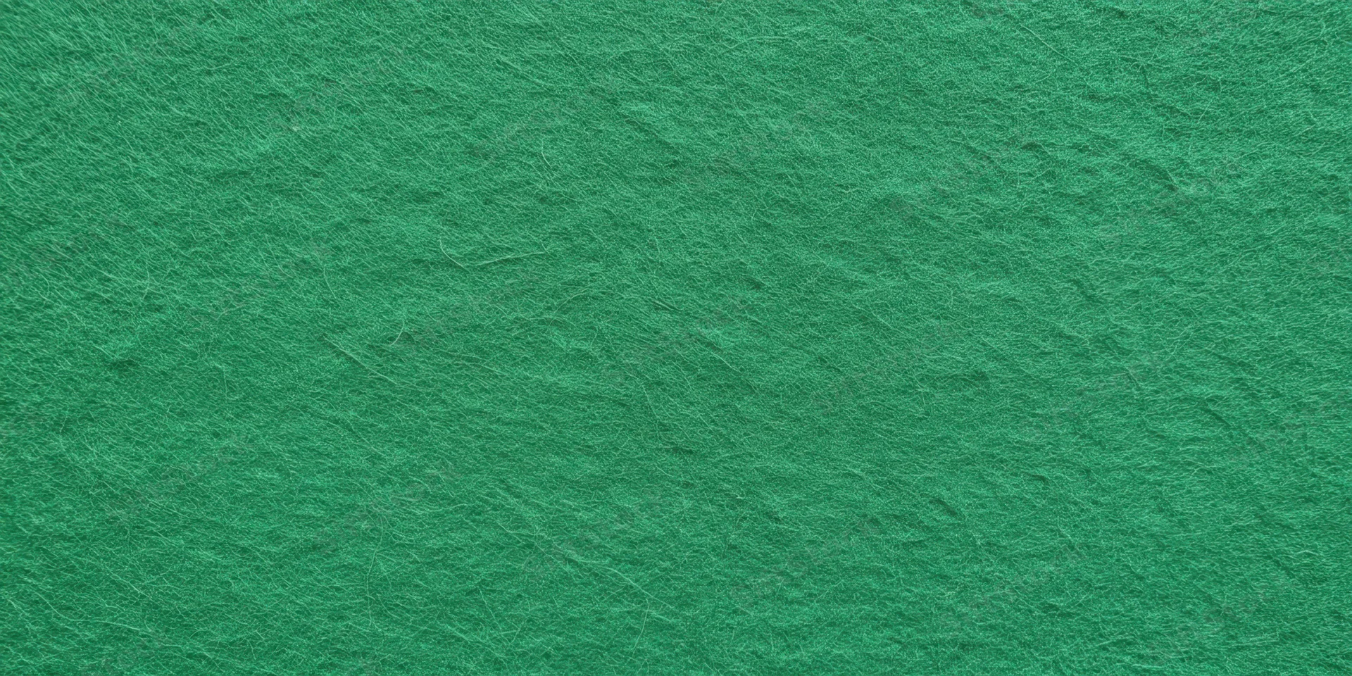 Close-up of a green felt surface showing fibrous texture and uniform color