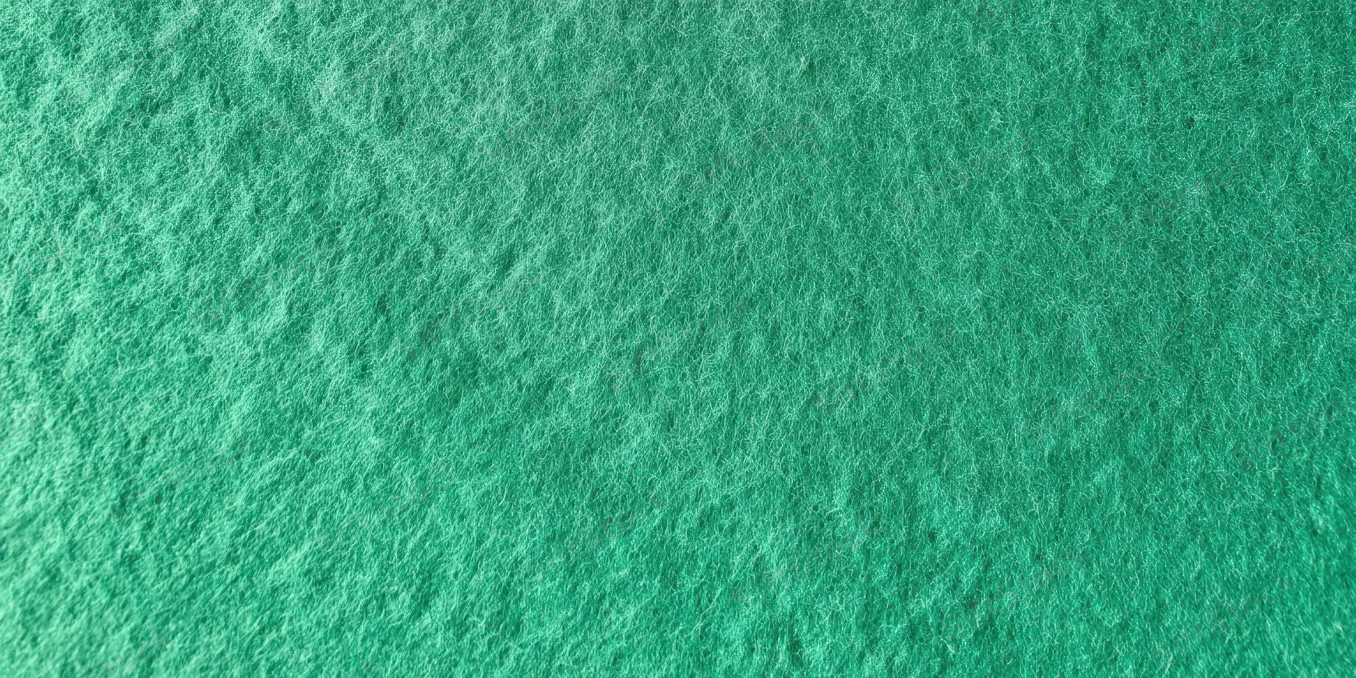 Close-up of a green felt-like textured surface filling the frame