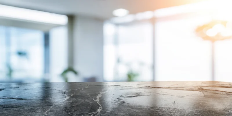 Smooth dark marble countertop in a modern office meeting room with blurred background and copyspace