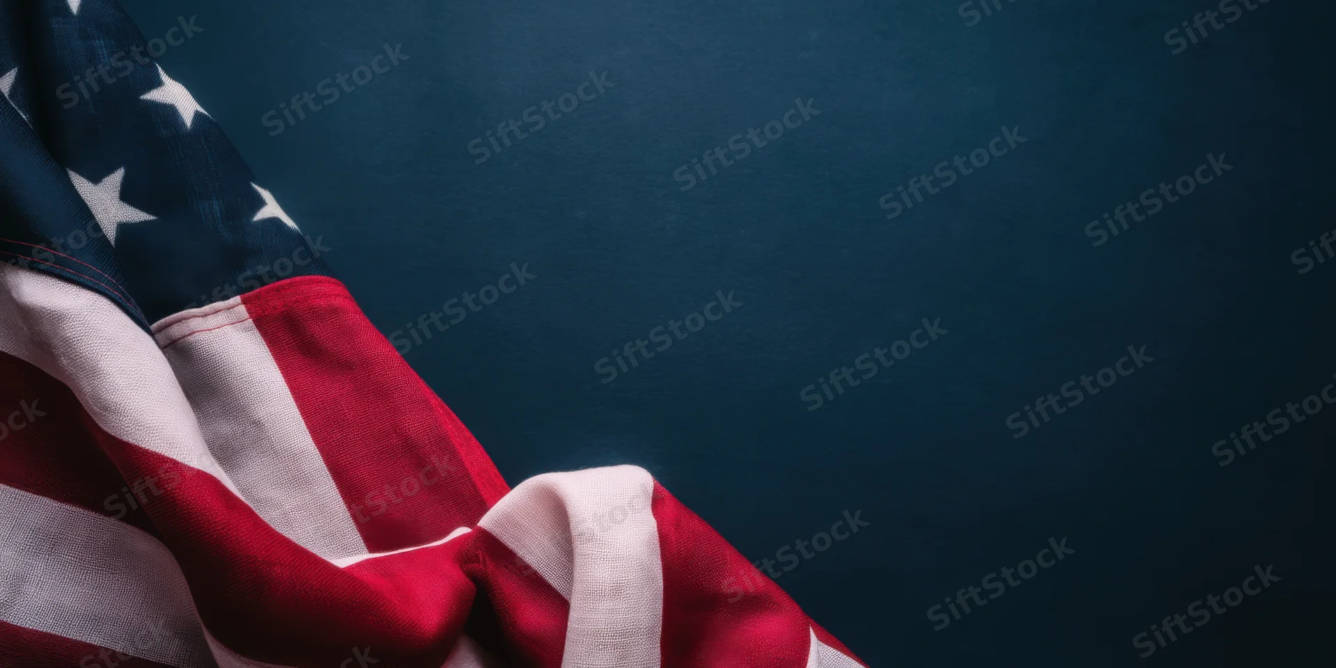 American flag draped over dark blue background with copyspace