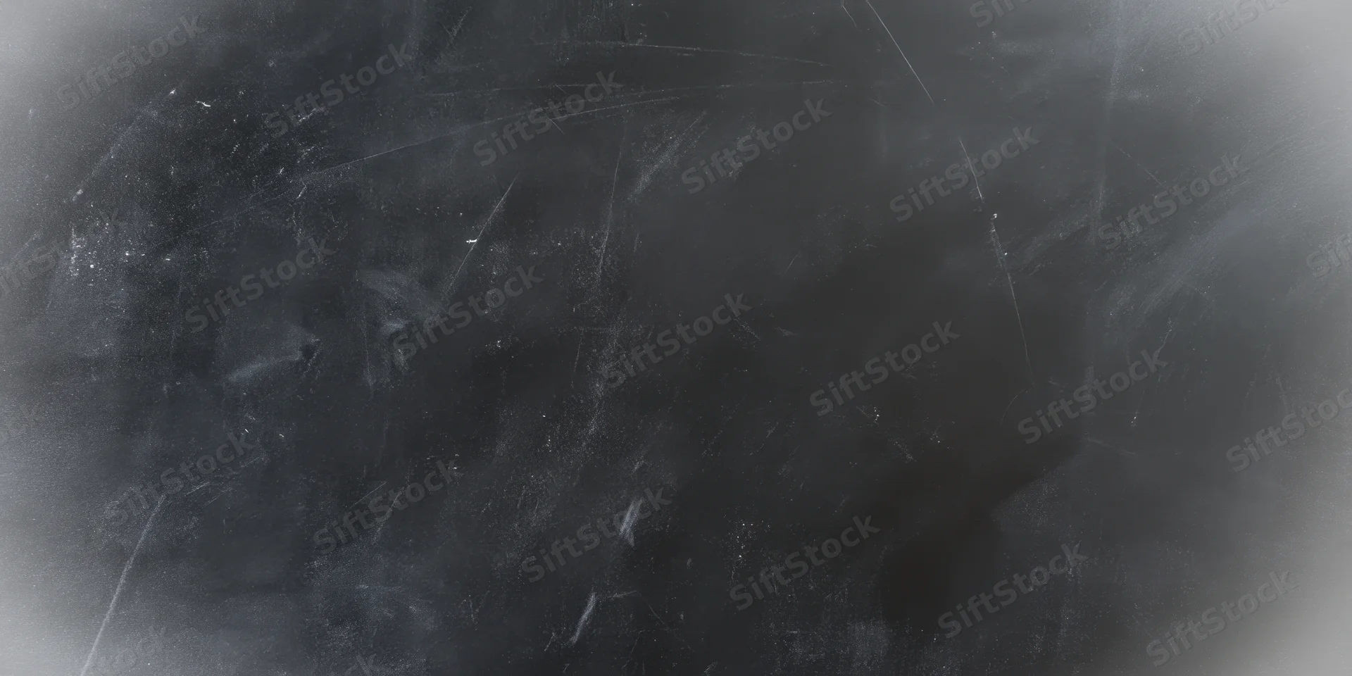 Dark textured chalkboard surface with faint scratches and smudges