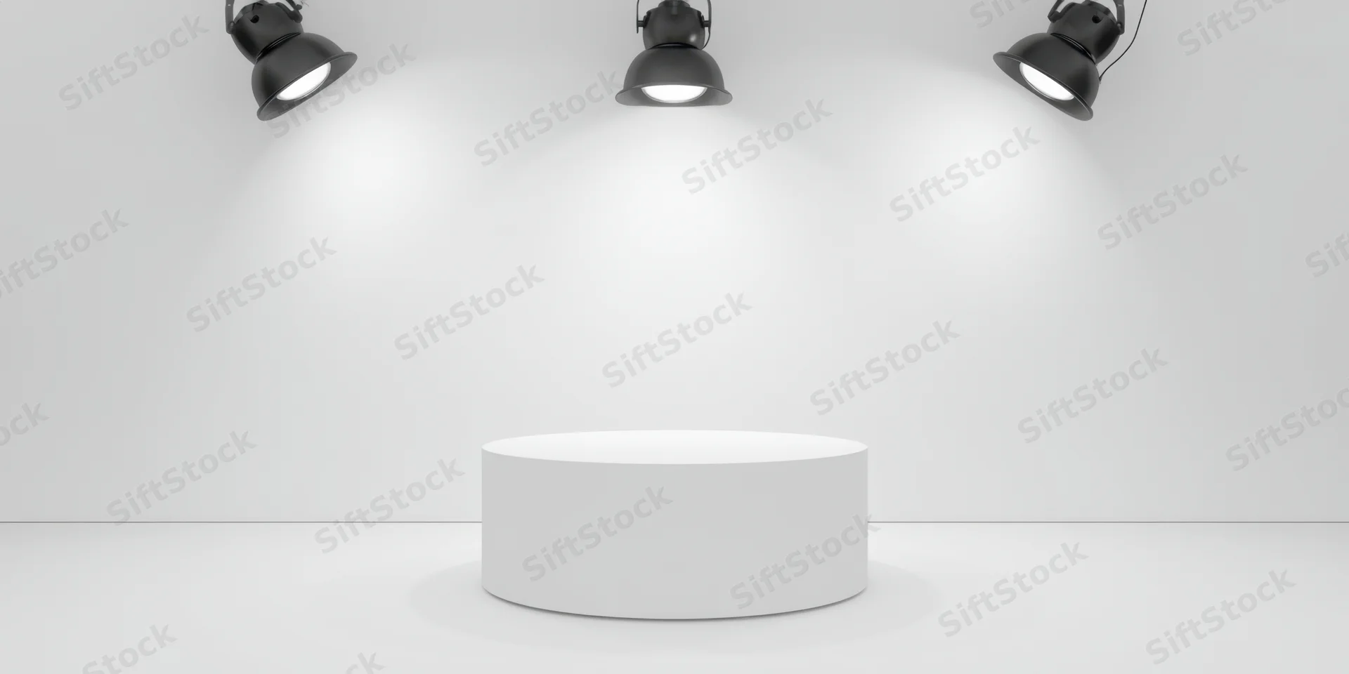 White cylindrical pedestal under three overhead spotlights in a minimalist studio space