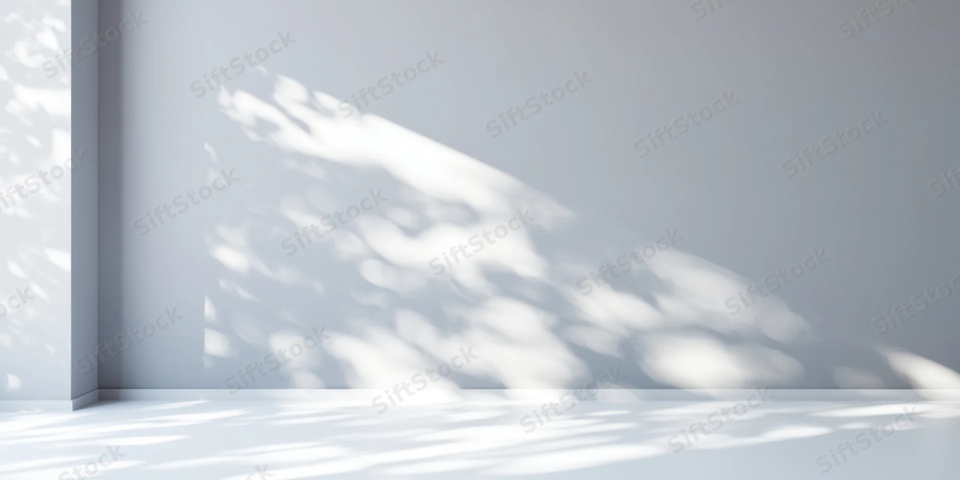 Dappled sunlight casting soft shadows on a minimalist white studio wall and floor
