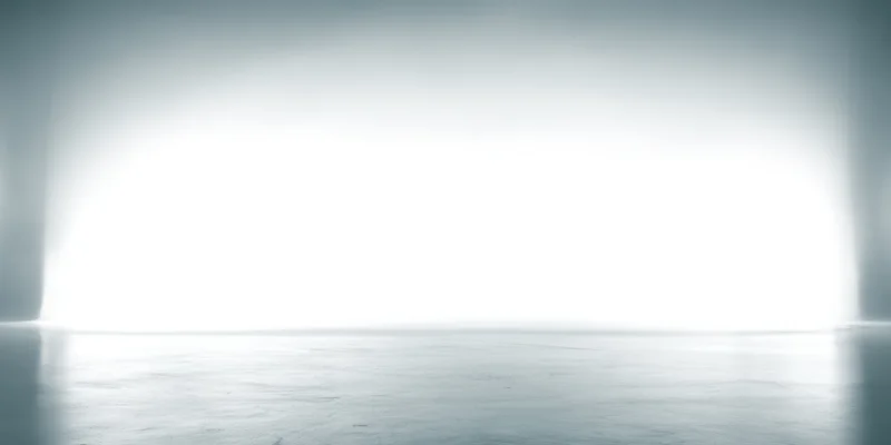 Soft white to light gray gradient backdrop in a studio interior with reflective floor and copyspace