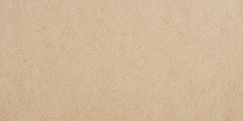 Smooth beige textured background with fine speckles and subtle grain