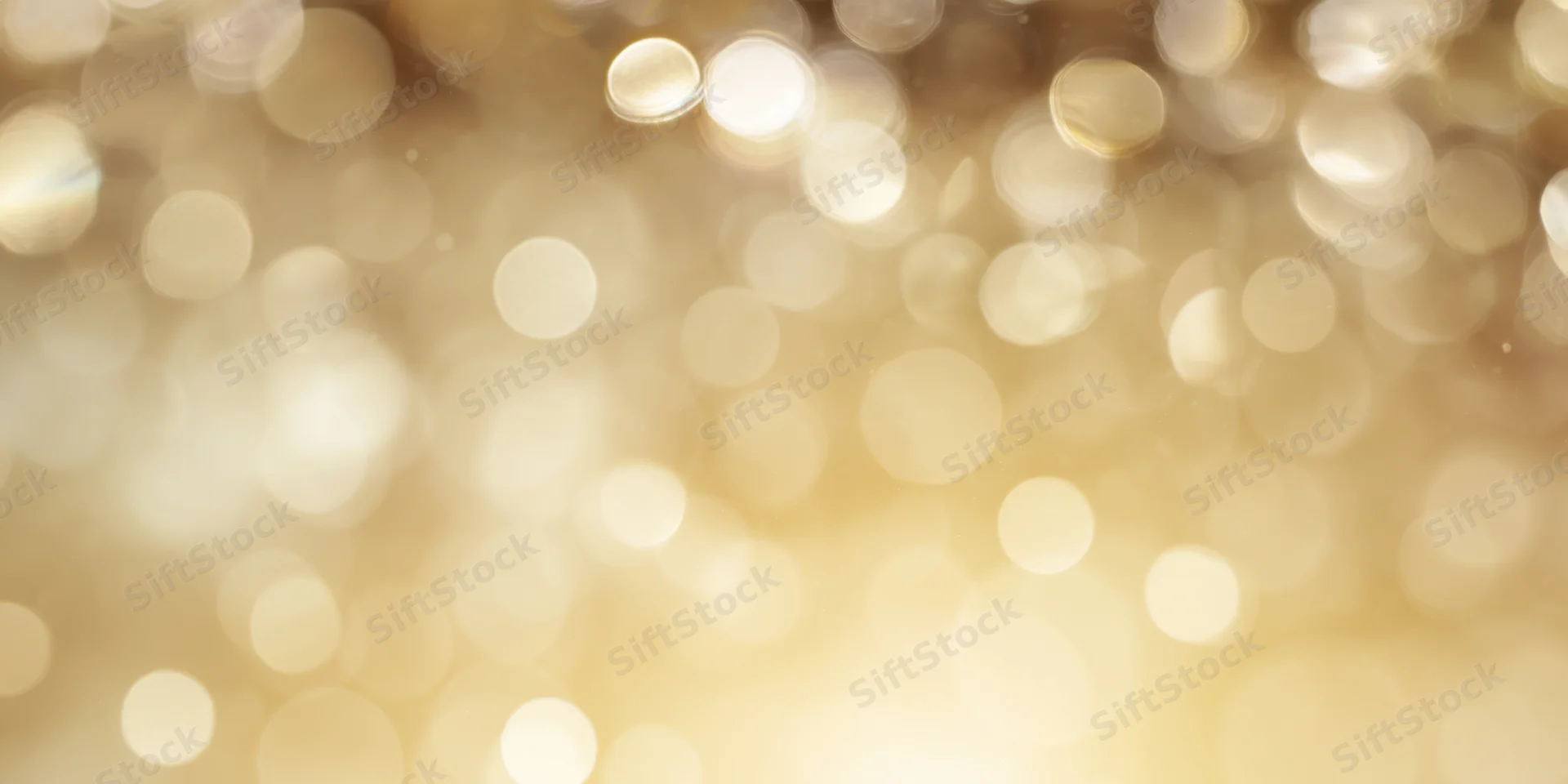 Soft golden bokeh background with scattered light orbs and warm glow
