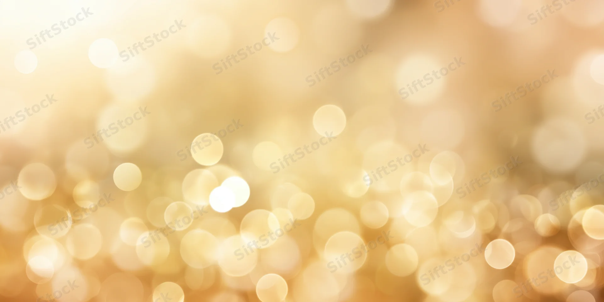Soft golden bokeh background with scattered light orbs and warm glow