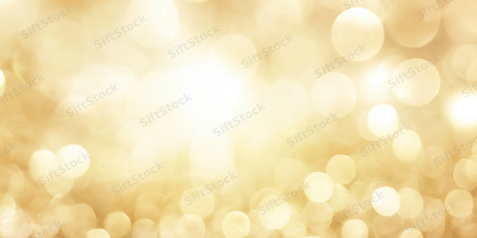 Soft golden bokeh background with scattered light orbs and warm glow