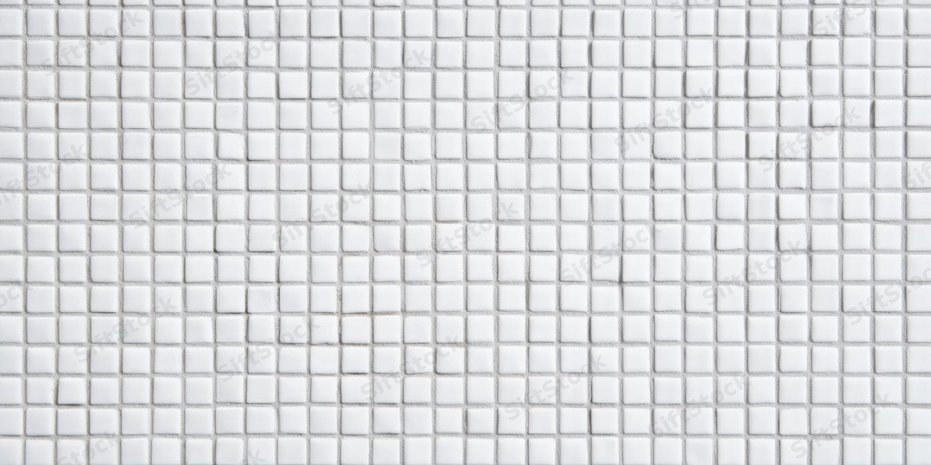 Seamless white square tile mosaic arranged in grid pattern on wall surface